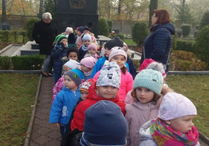 Dzieci z gr "Krasnali" i "Elfów" przed pomnikiem Nieznanego Żołnierza w Grocholicach